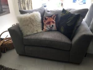 A soggy sofa with pillows on it